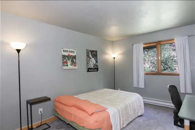 a bathroom with a granite countertop sink and a large mirror