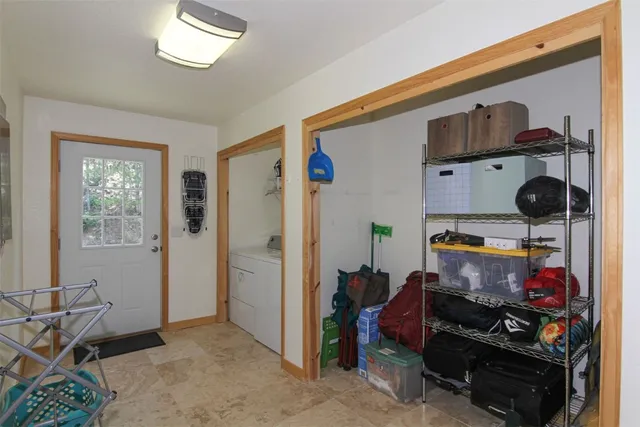 a view of an empty room with shelves and a window