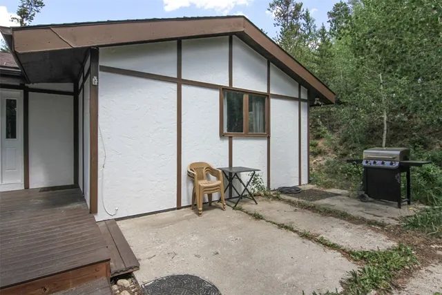 a view of a hallway with wooden floor and a chandelier