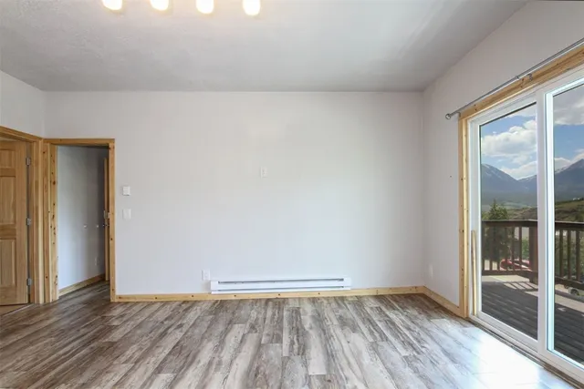 a view of an empty room with closet and windows