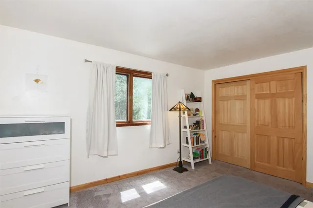 a view of an empty room and wooden floor