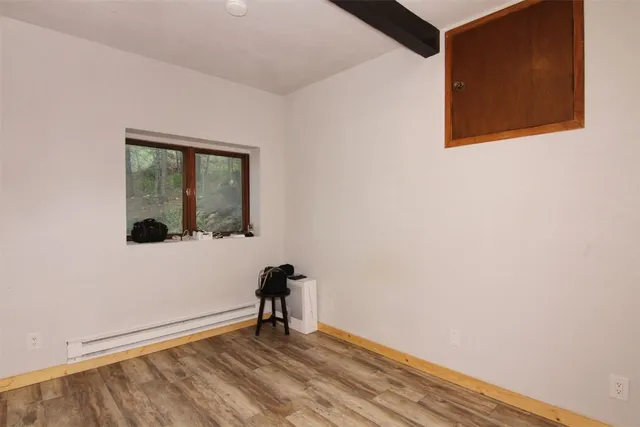 a view of a closet with wooden floor