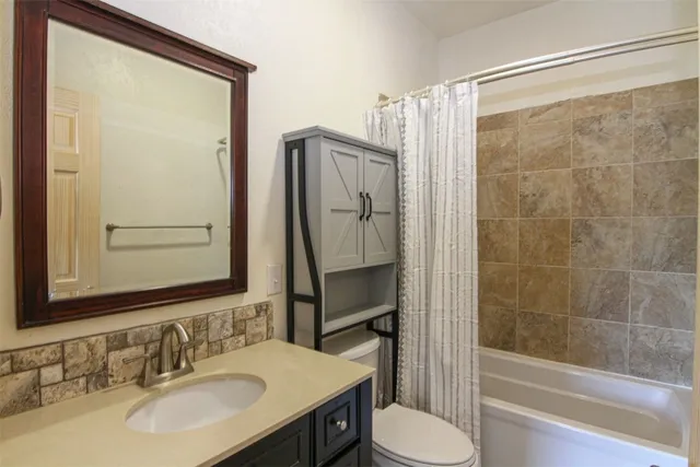 an empty room with wooden floor and closet area