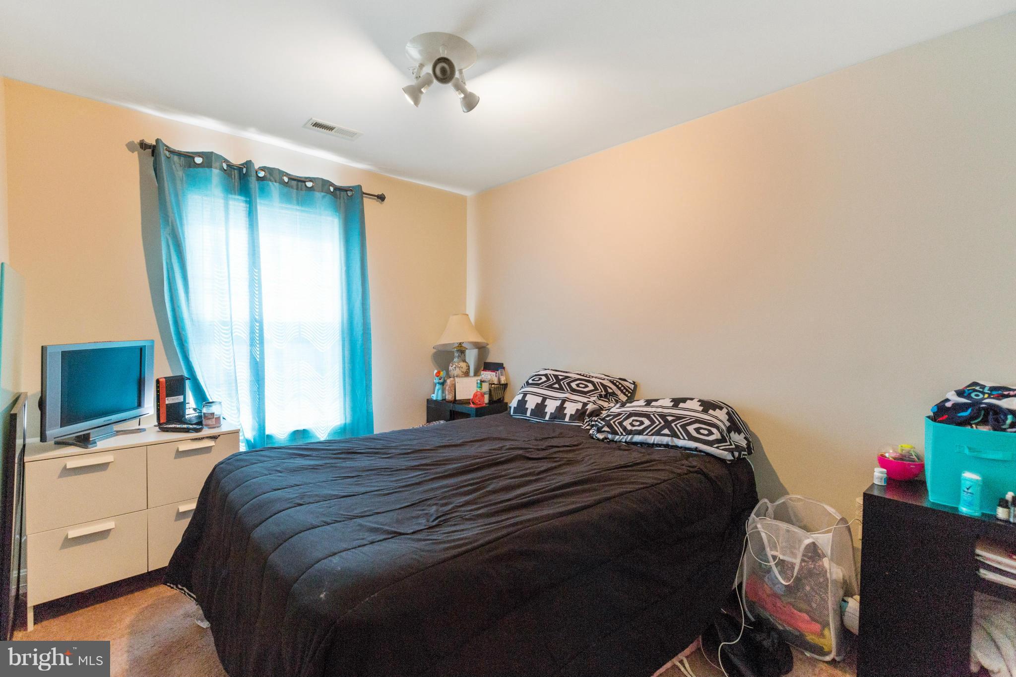 2005 Bell Point Court Odenton, MD 21113 - Photo 13 of 24 a bedroom with a bed and a flat tv screen