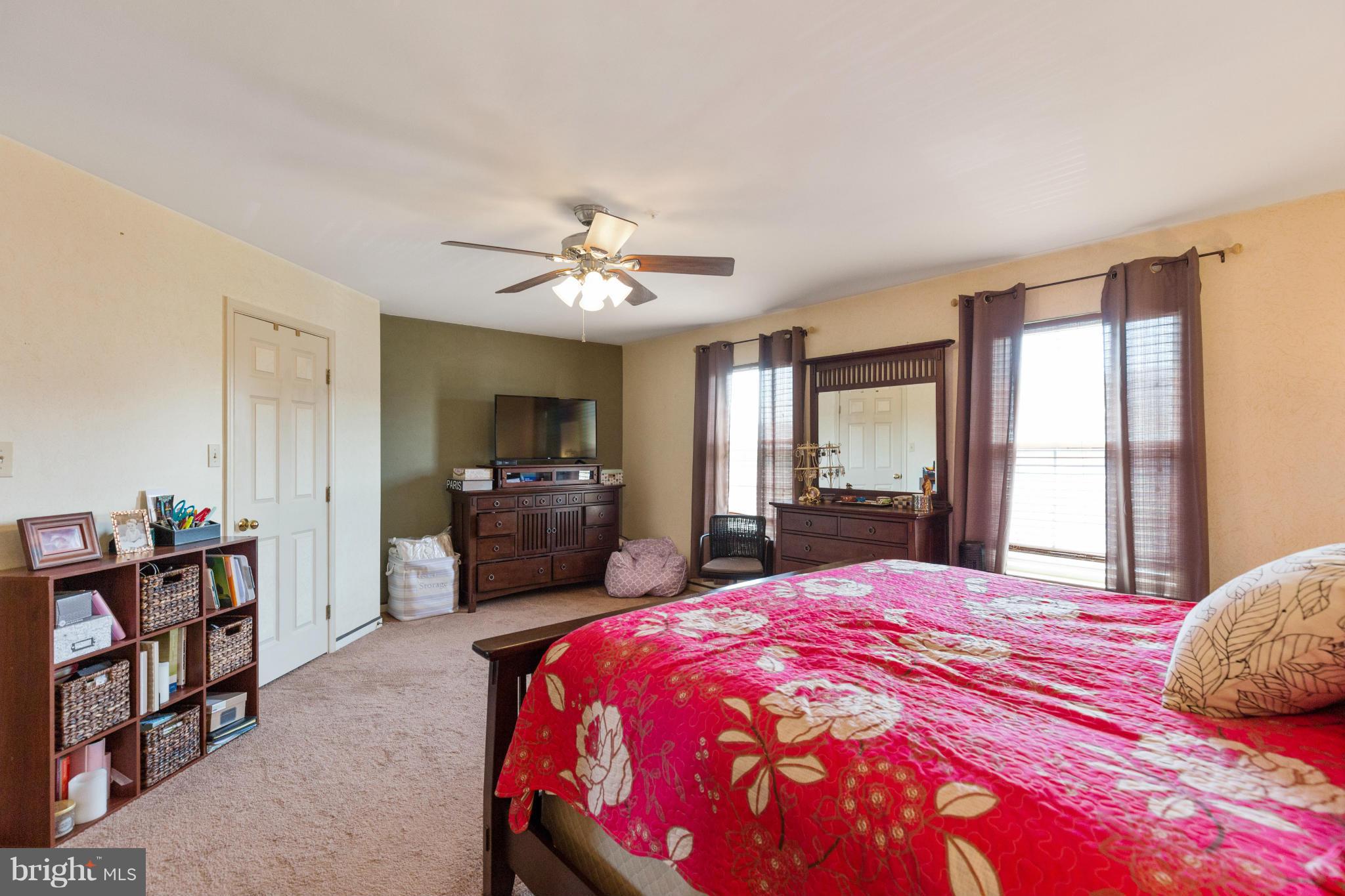 2005 Bell Point Court Odenton, MD 21113 - Photo 18 of 24 a spacious bedroom with a bed a dresser and a chandelier