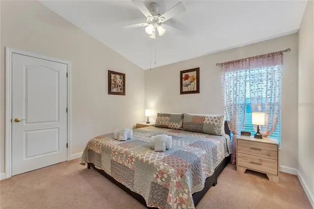 a bedroom with a bed and a wooden floor