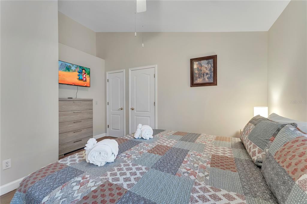 620 Old Bridge Circle Davenport, FL 33897 - Photo 12 of 22 a bedroom with a bed and a wooden floor
