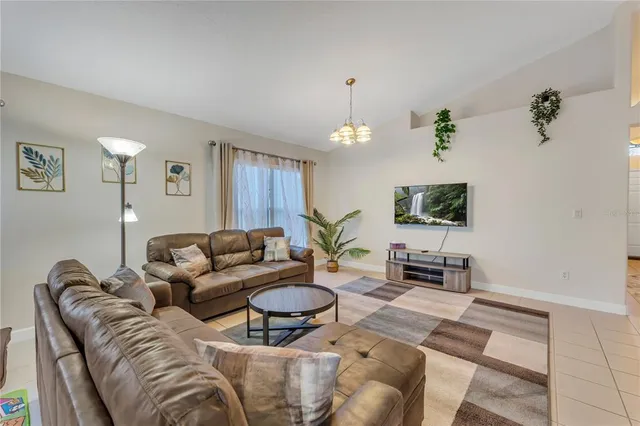a living room with furniture a lamp and a window