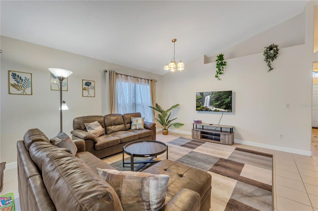 620 Old Bridge Circle Davenport, FL 33897 - Photo 4 of 22 a living room with furniture a lamp and a window