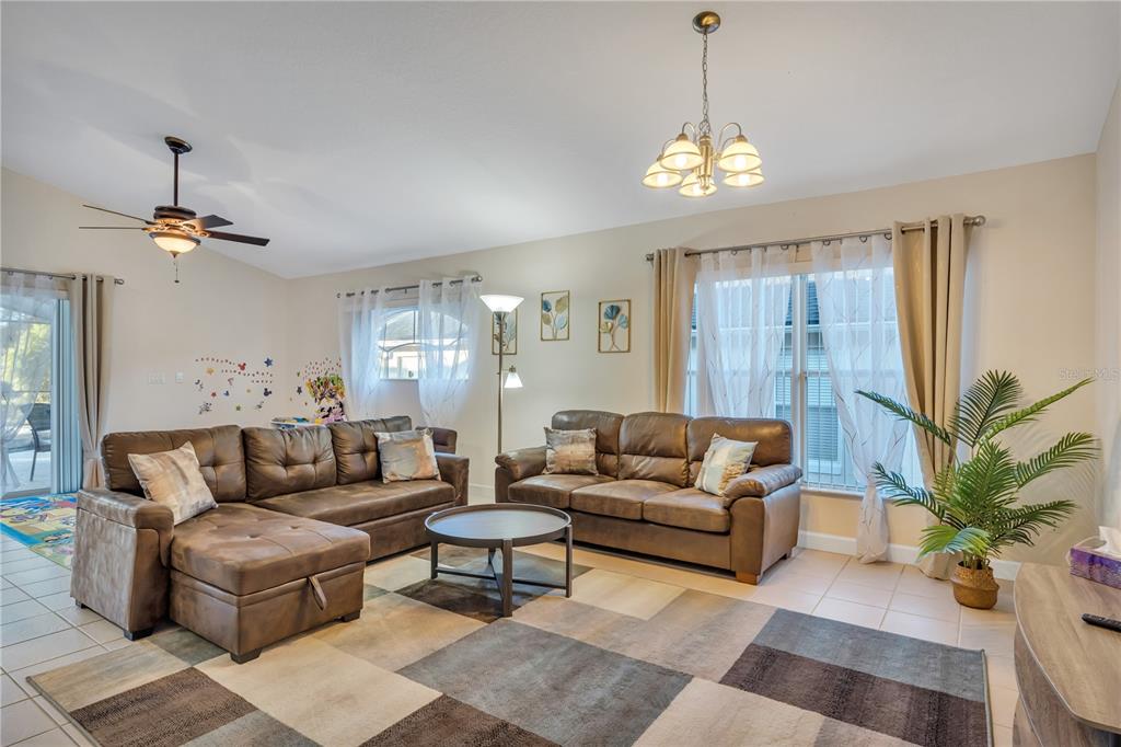 620 Old Bridge Circle Davenport, FL 33897 - Photo 5 of 22 a living room with furniture and a chandelier