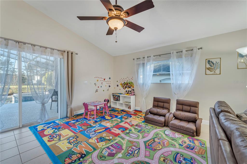 620 Old Bridge Circle Davenport, FL 33897 - Photo 8 of 22 a bedroom with a bed and a chandelier