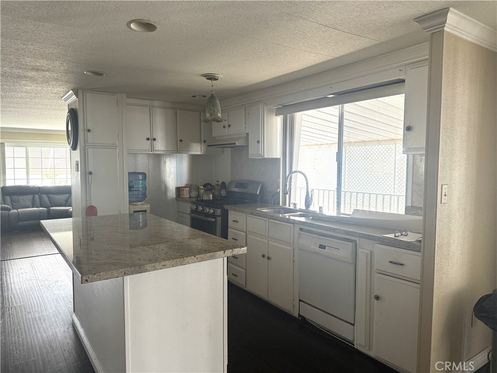 11250 Beach Boulevard, Unit 83 Stanton, CA 90680 - Photo 3 of 5 a kitchen with stainless steel appliances granite countertop a sink stove and refrigerator