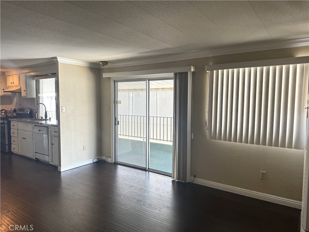 11250 Beach Boulevard, Unit 83 Stanton, CA 90680 - Photo 5 of 5 an empty room with wooden floor and windows