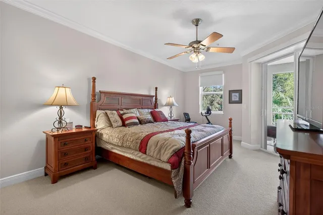 a bedroom with a bed chandelier and a window
