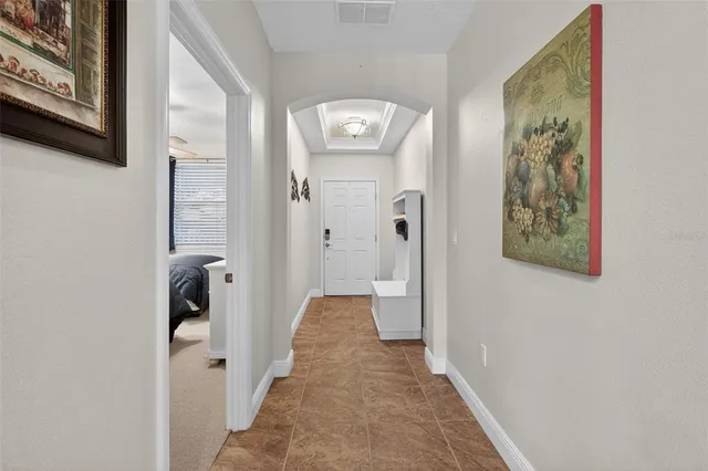 a view of a hallway with paintings on the wall
