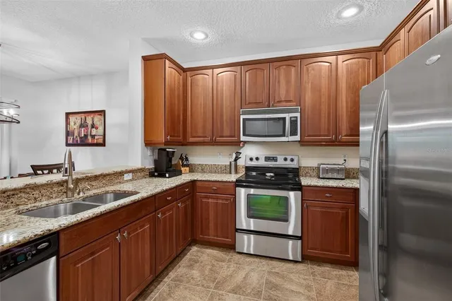 a kitchen with a sink stove and refrigerator