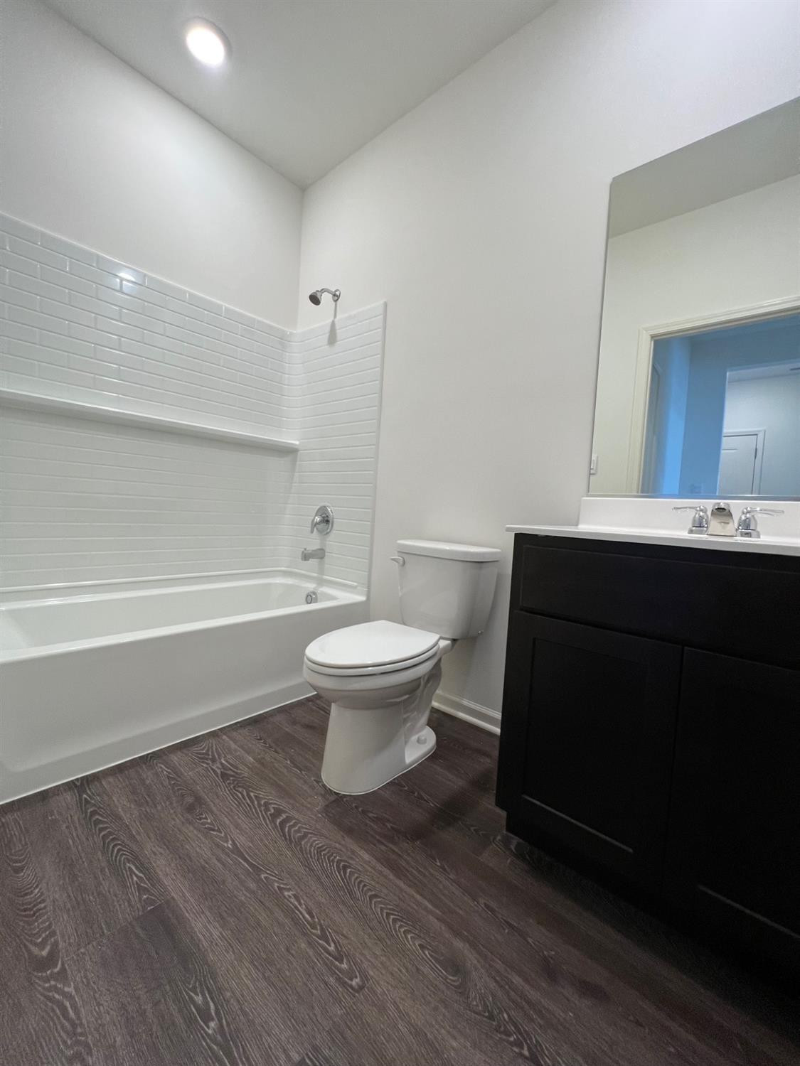 10400 Morse Place Crown Point, IN 46307 - Photo 11 of 33 a bathroom with a sink toilet a mirror and shower