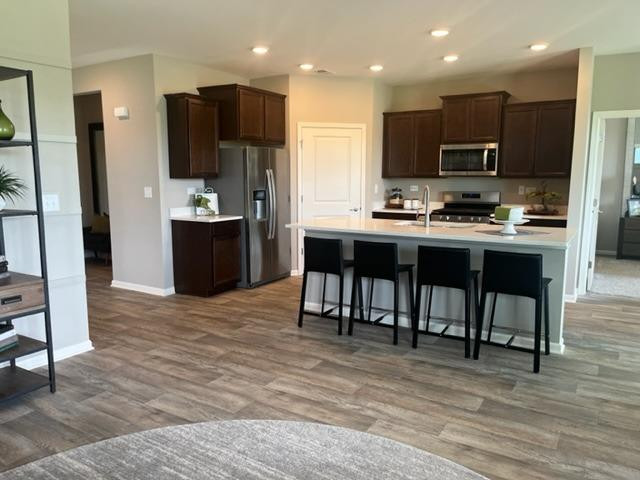 10400 Morse Place Crown Point, IN 46307 - Photo 22 of 33 a kitchen with stainless steel appliances kitchen island granite countertop a refrigerator and a stove top oven