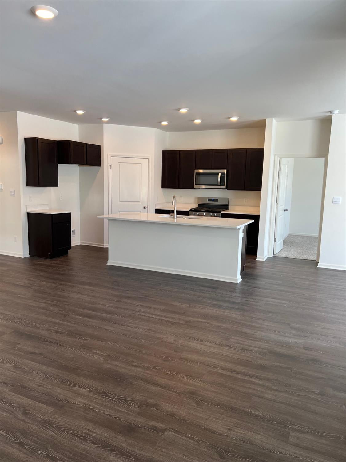 10400 Morse Place Crown Point, IN 46307 - Photo 4 of 33 a view of kitchen with stainless steel appliances wooden floor and living room