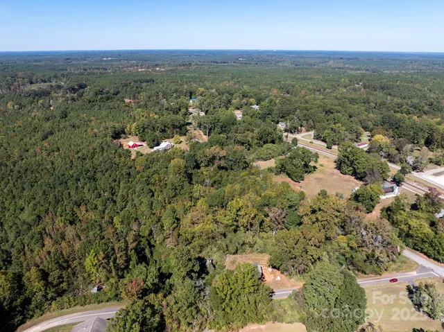 an aerial view of a houses with a yard