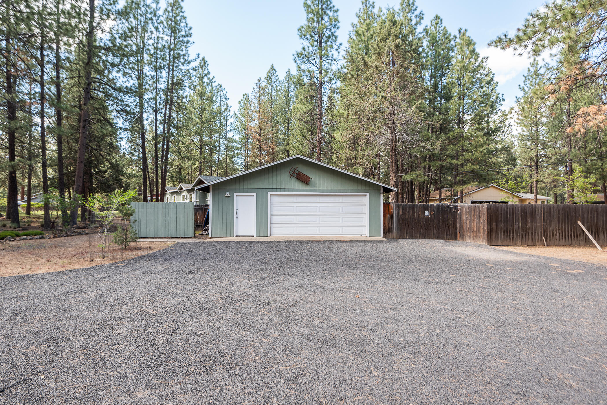 60055 Hopi Road Bend, OR 97702 - Photo 36 of 37 a view of a house with a yard and garage