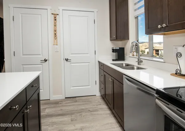 a kitchen with a sink stove and cabinets