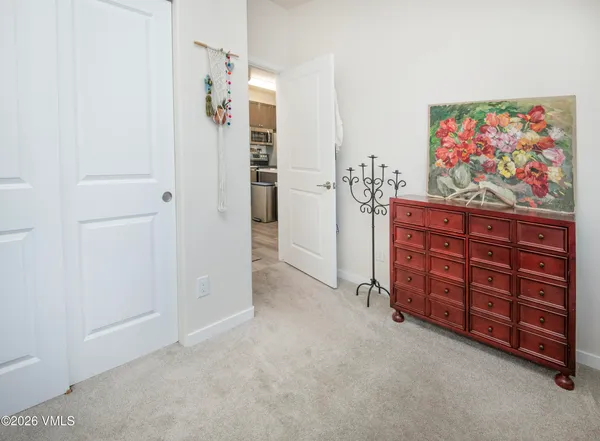 an empty room with furniture and painting on the wall