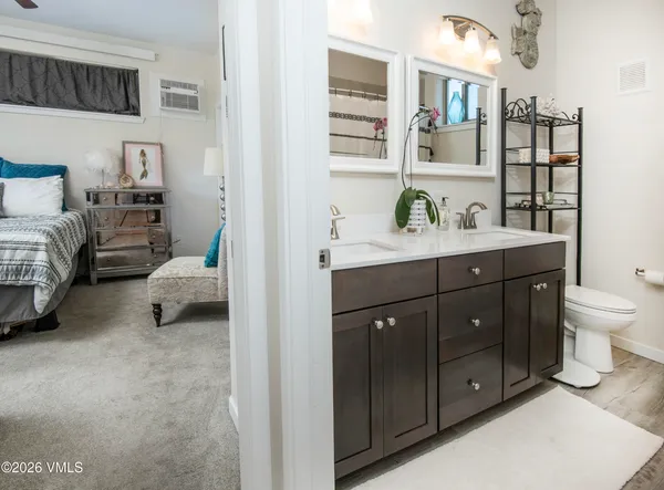 a en suite bathroom with a double vanity sink and a mirror
