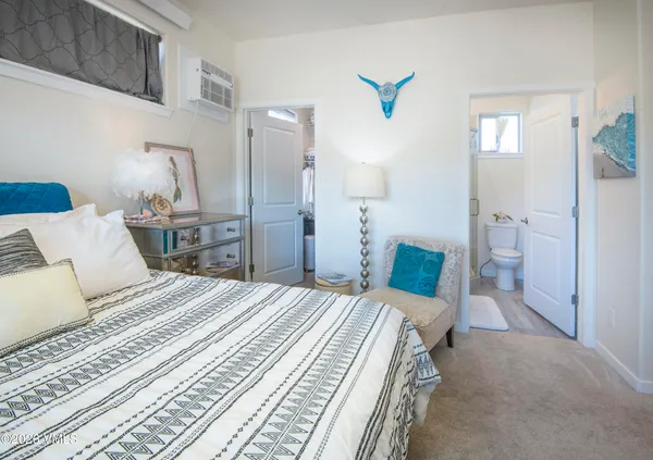 a bedroom with a bed and a mirror