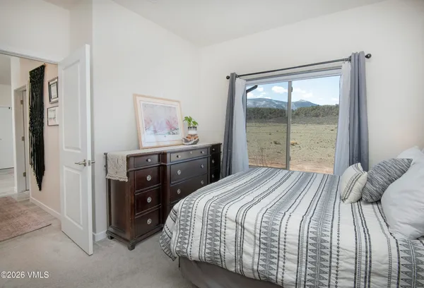 a bedroom with a bed and a large window