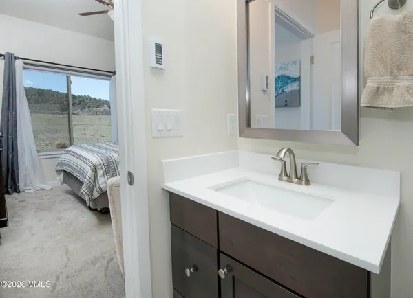 a en suite bathroom with a sink and a mirror