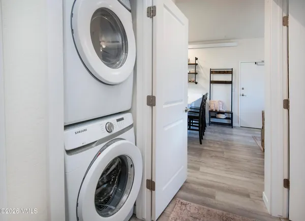 a view of a hallway with washer and dryer