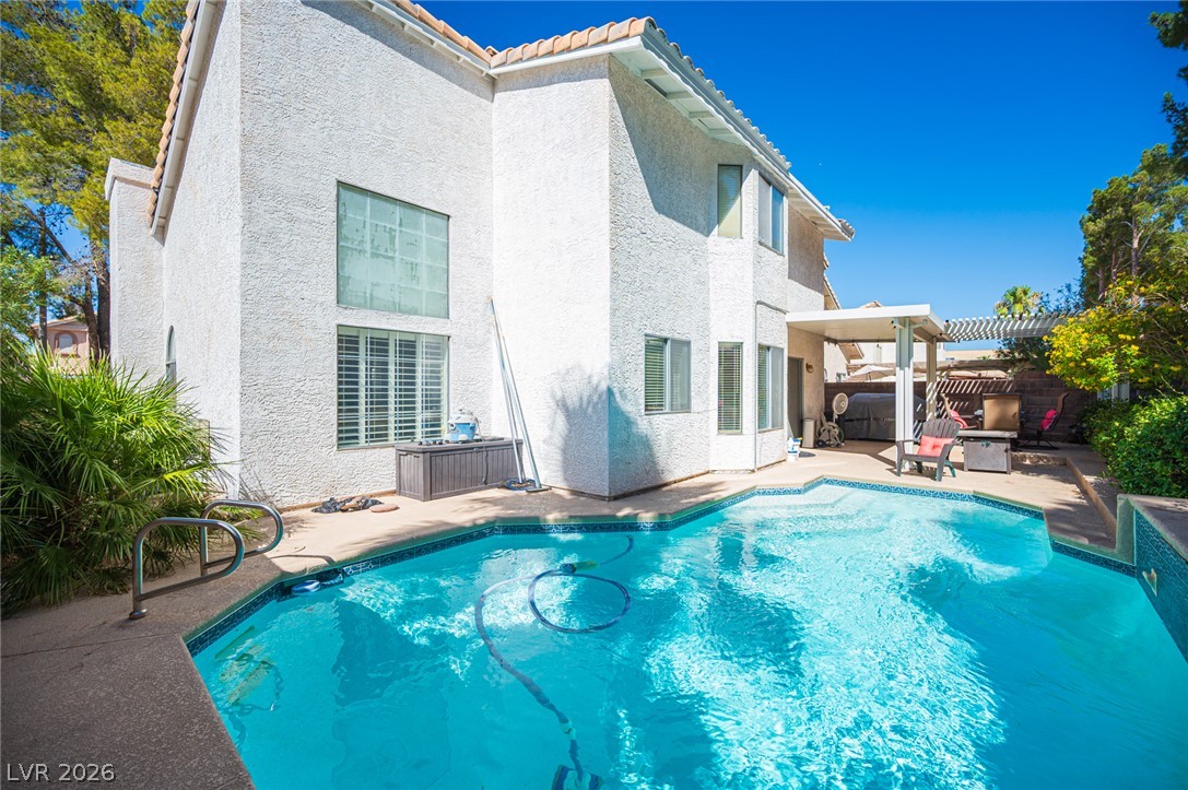718 Rusty Spur Drive Henderson, NV 89014 - Photo 28 of 50 Relax poolside in this backyard retreat, complete with a private swimming pool and a covered patio.