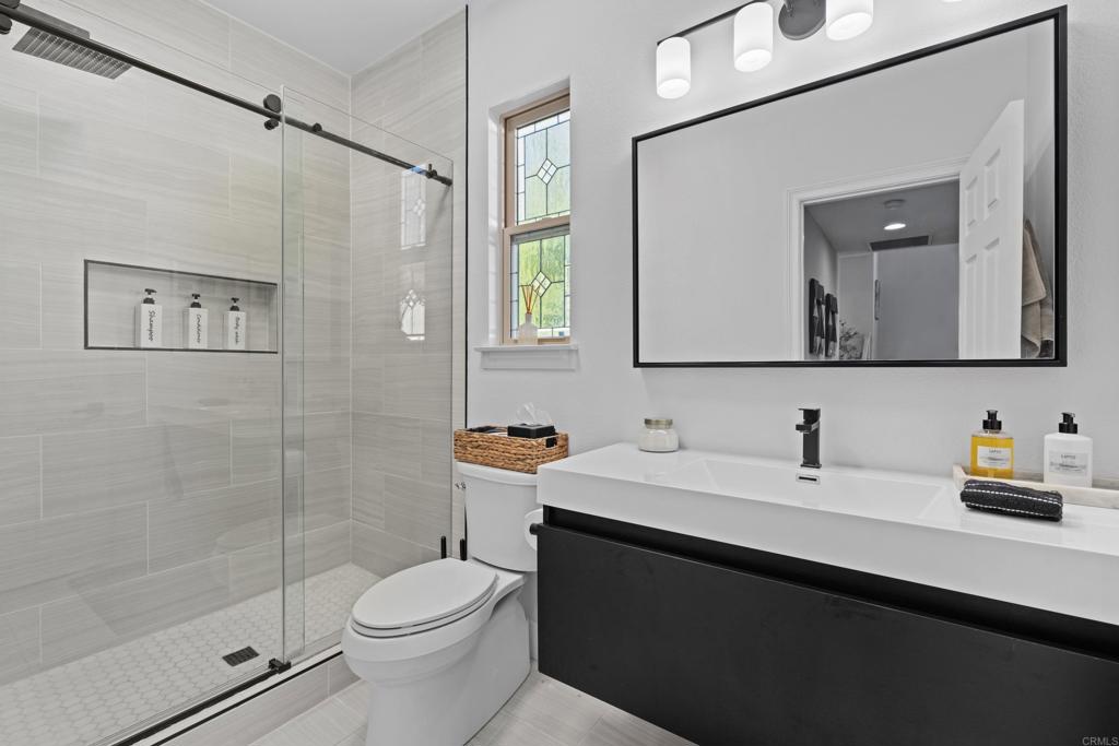 887 Genoa Way San Marcos, CA 92078 - Photo 24 of 41 a bathroom with a sink toilet and shower