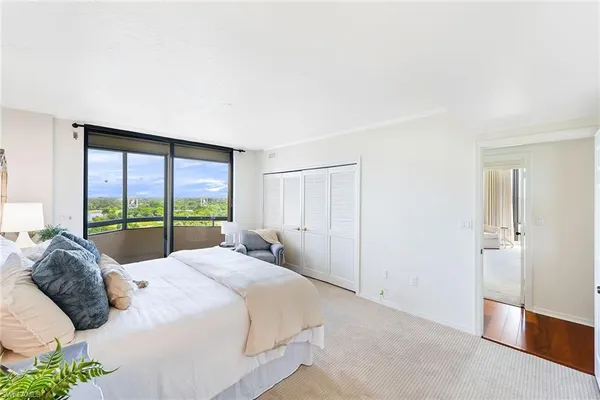 a large bed sitting in a bedroom next to a window