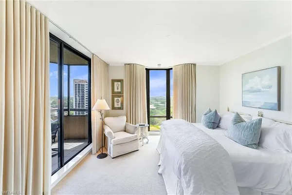 a bedroom with a balcony a bed and a couch