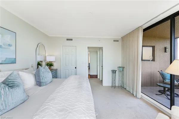 a bedroom with furniture and a bathroom