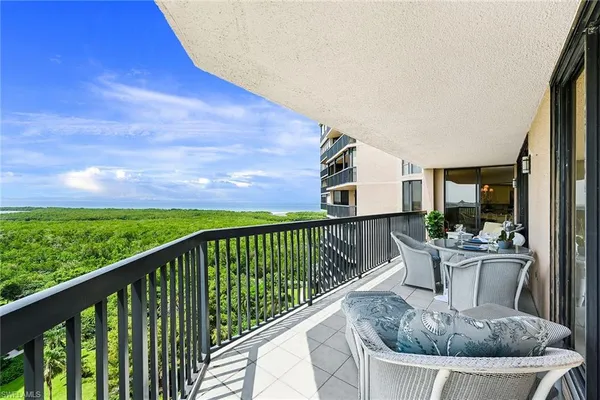 a view of balcony with couch and chairs