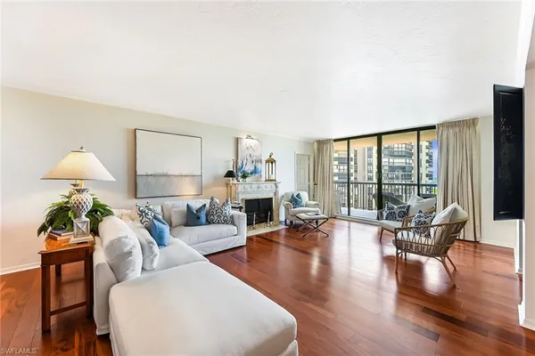 a living room with furniture large window and a table