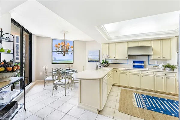 a kitchen with stainless steel appliances kitchen island granite countertop a sink and cabinets