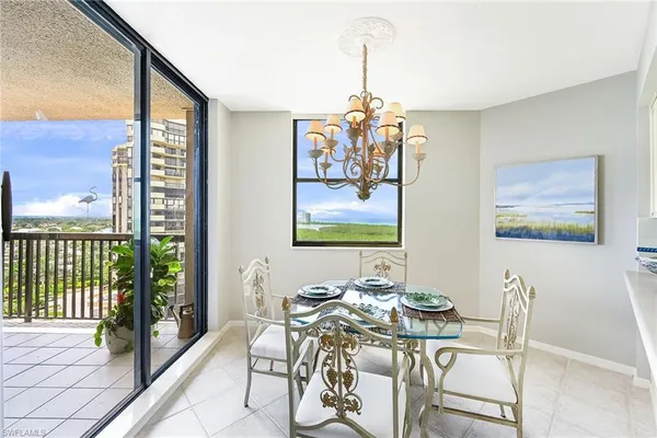 a view of a dining room with furniture a chandelier and wooden floor
