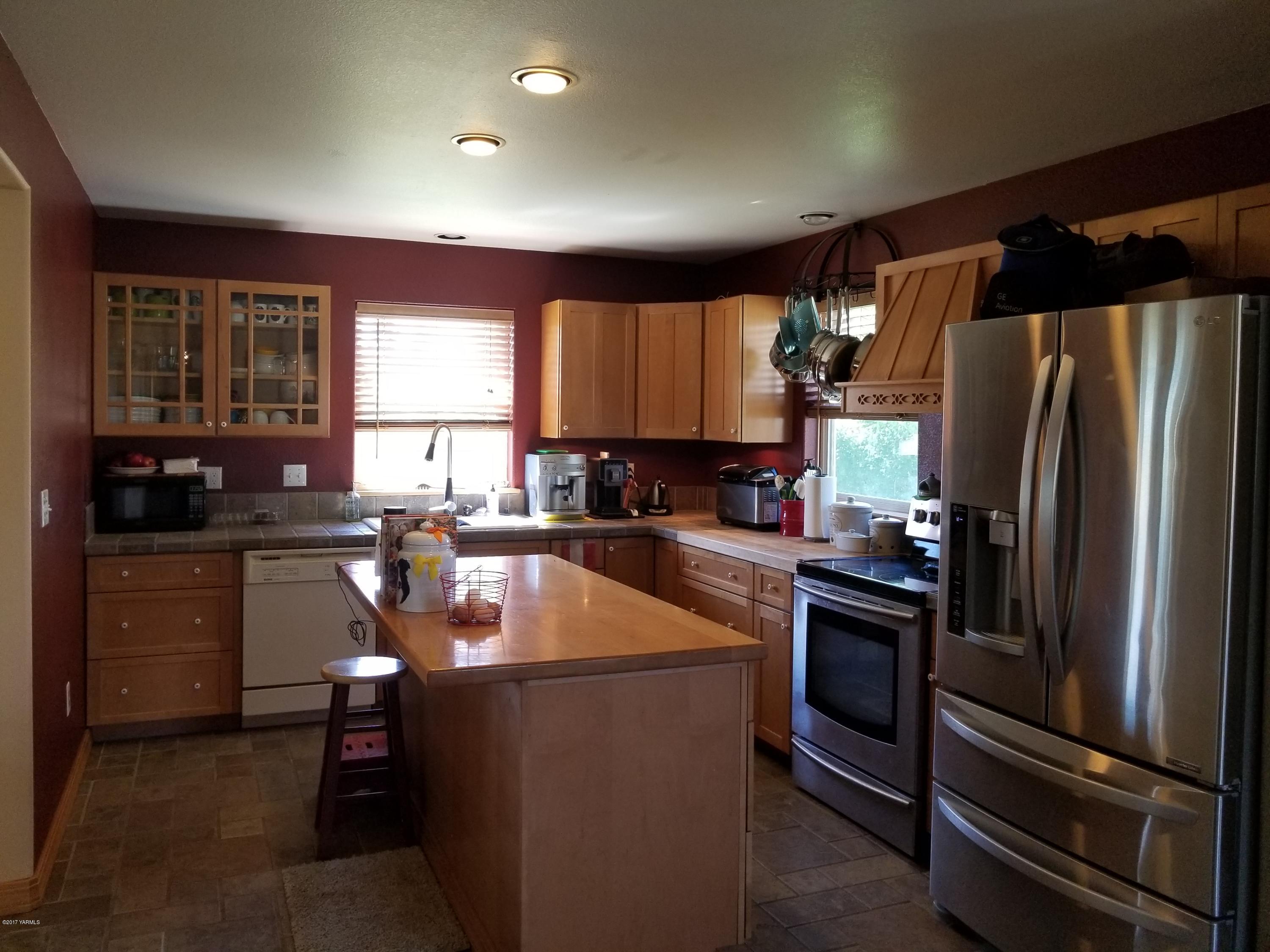 810 Red Tail Road Yakima, WA 98908 - Photo 1 of 42 a kitchen with stainless steel appliances granite countertop a refrigerator a sink a stove a microwave and island