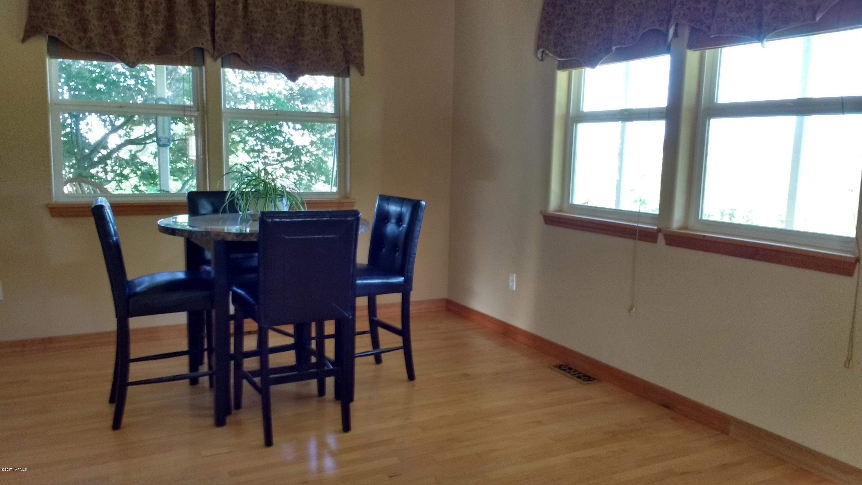 810 Red Tail Road Yakima, WA 98908 - Photo 13 of 42 a view of a dining room with furniture window and outside view