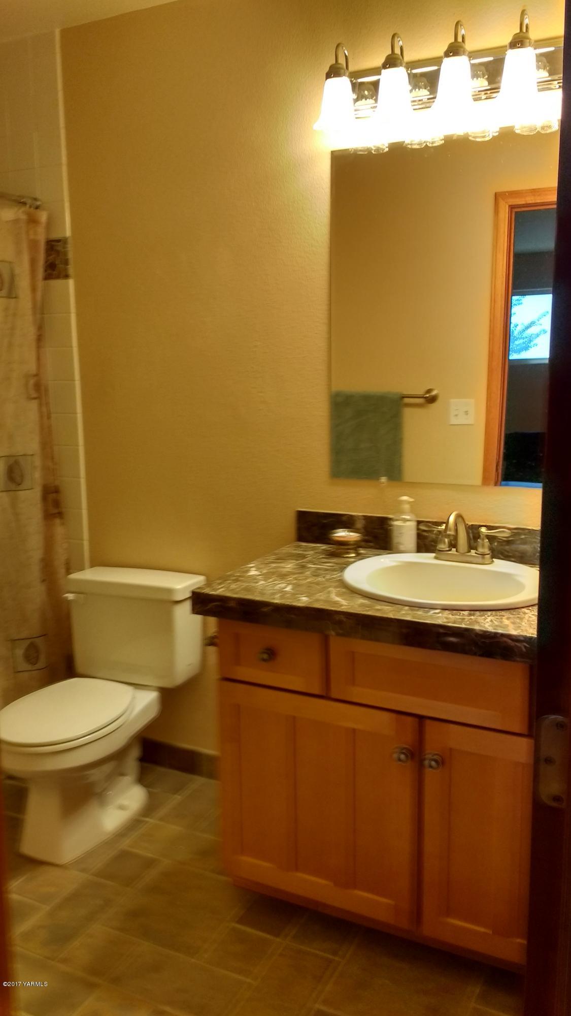 810 Red Tail Road Yakima, WA 98908 - Photo 15 of 42 a bathroom with a granite countertop sink and a mirror