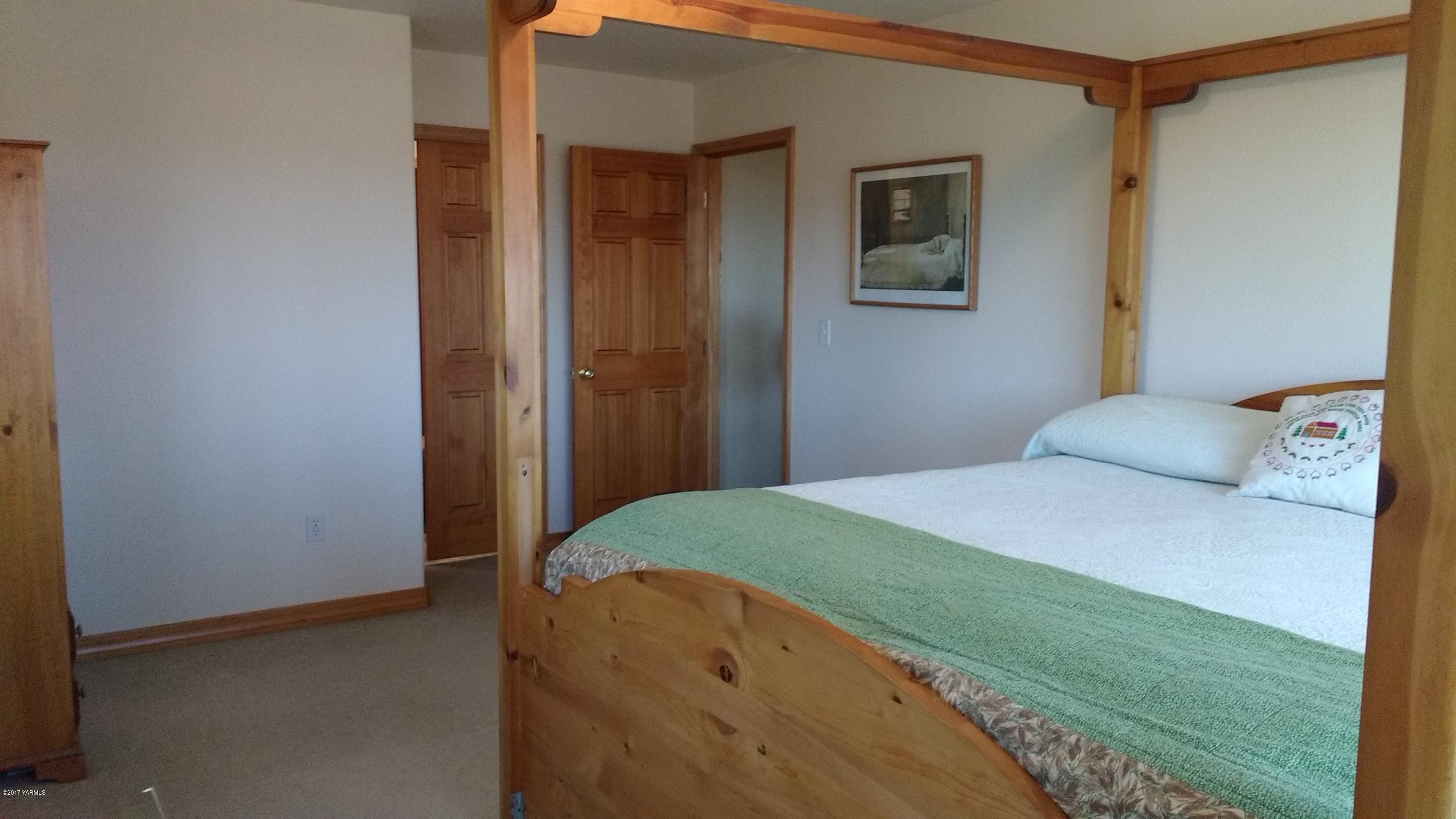 810 Red Tail Road Yakima, WA 98908 - Photo 17 of 42 a bedroom with a bed and a cabinets