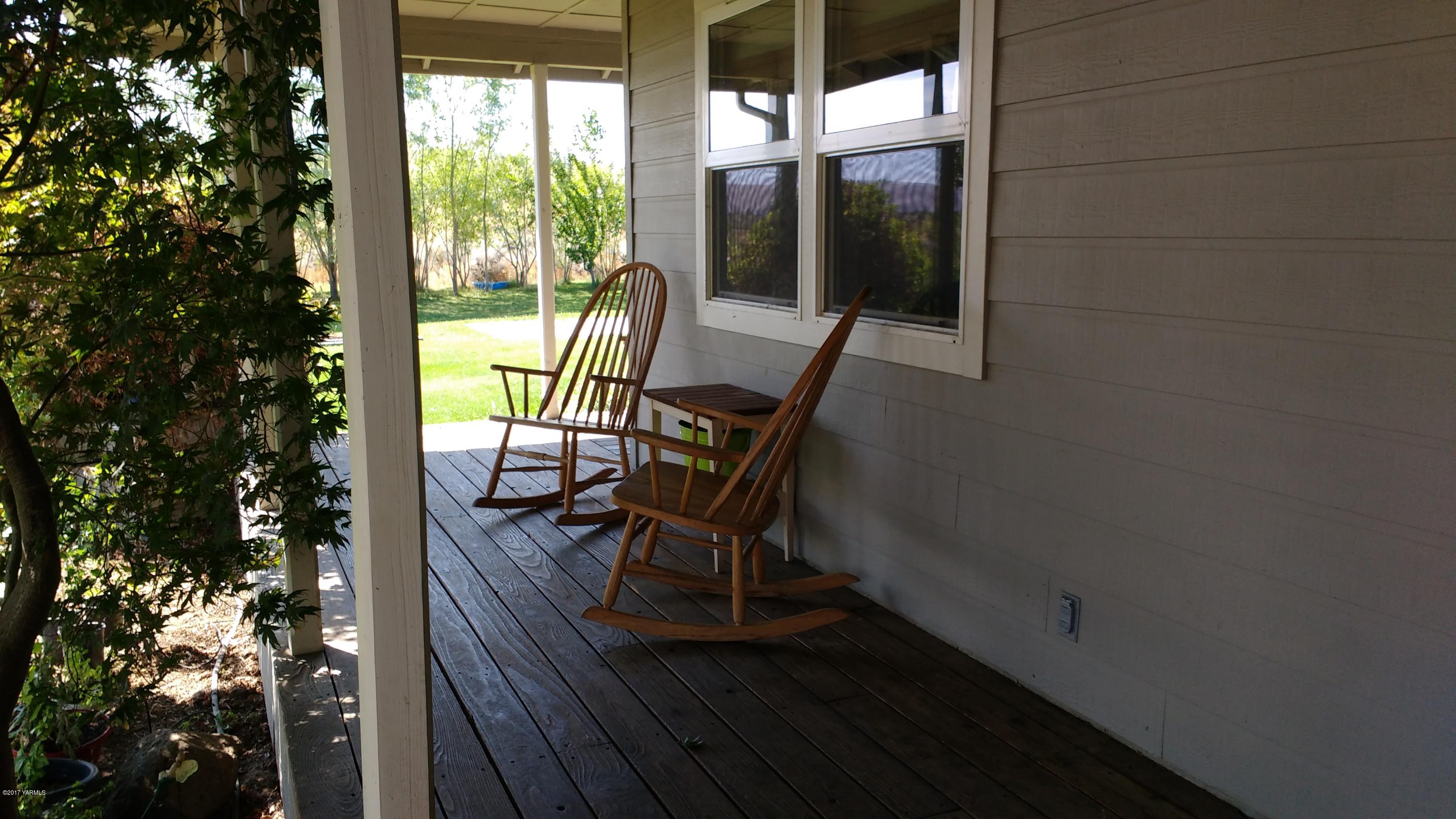 810 Red Tail Road Yakima, WA 98908 - Photo 3 of 42 a view of a porch with chairs and backyard