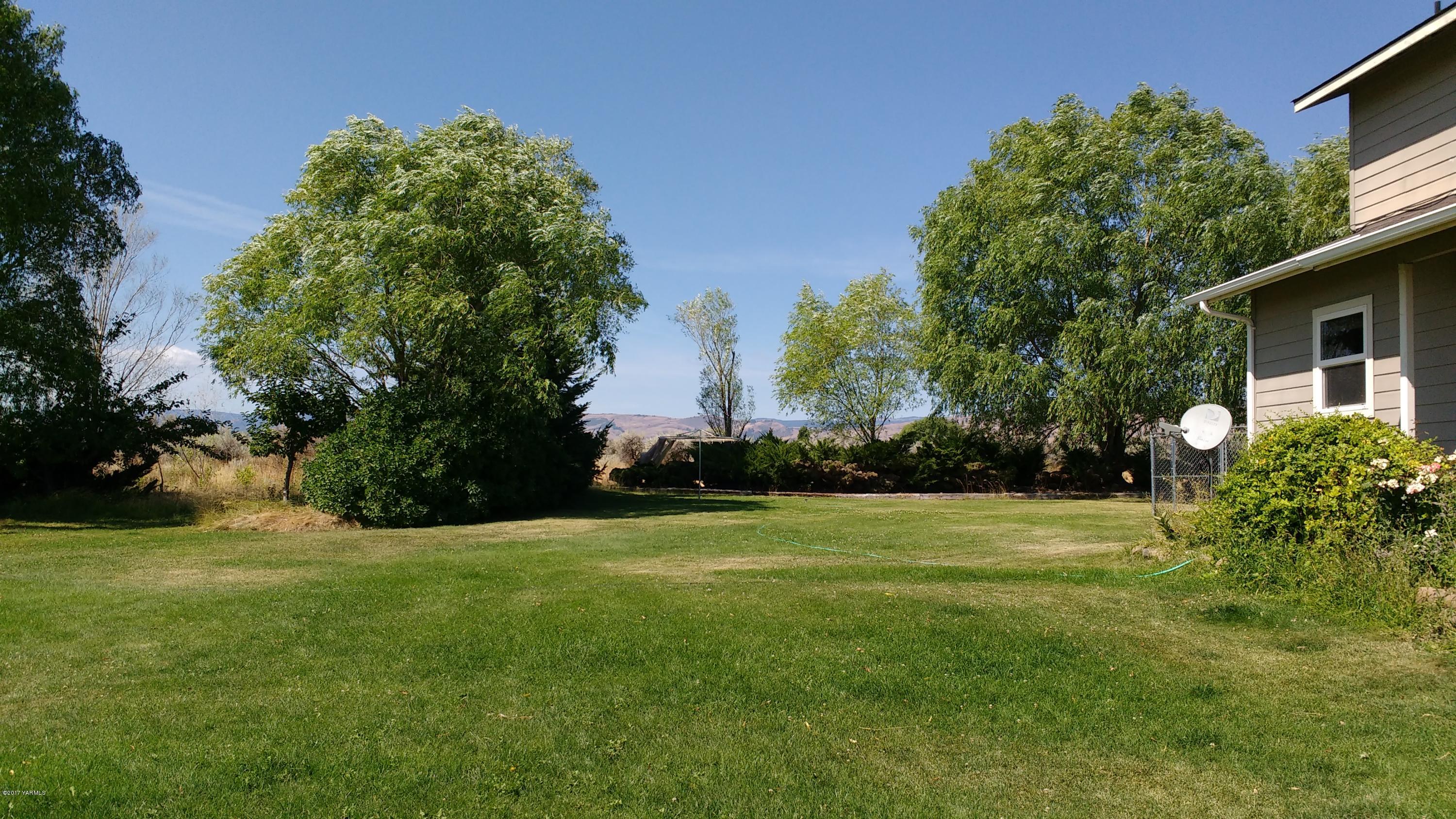 810 Red Tail Road Yakima, WA 98908 - Photo 26 of 42 a view of a big yard with plants and large trees