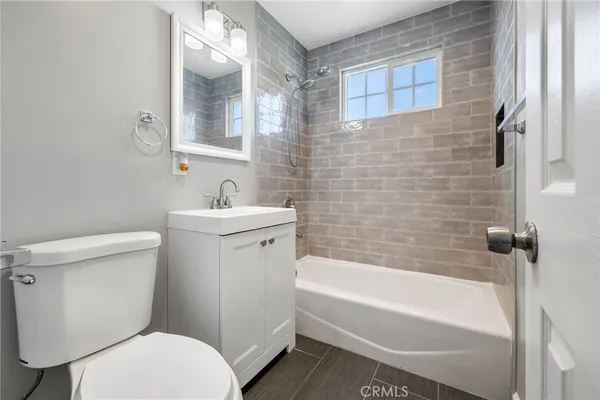 a bathroom with a sink a toilet and bathtub