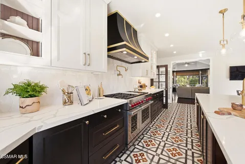 a kitchen with stainless steel appliances a sink stove and cabinets