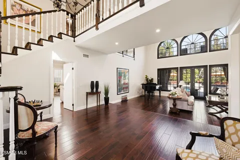 a view of a livingroom with furniture hardwood floor and a ceiling fan
